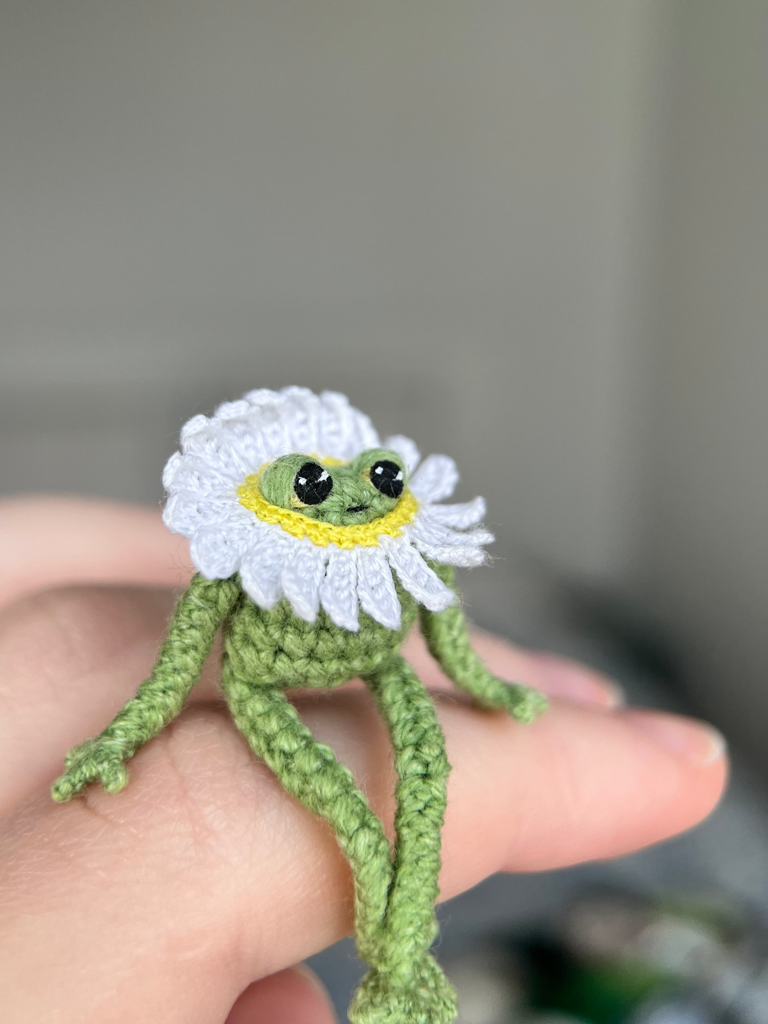Mini crochet frog with a daisy collar