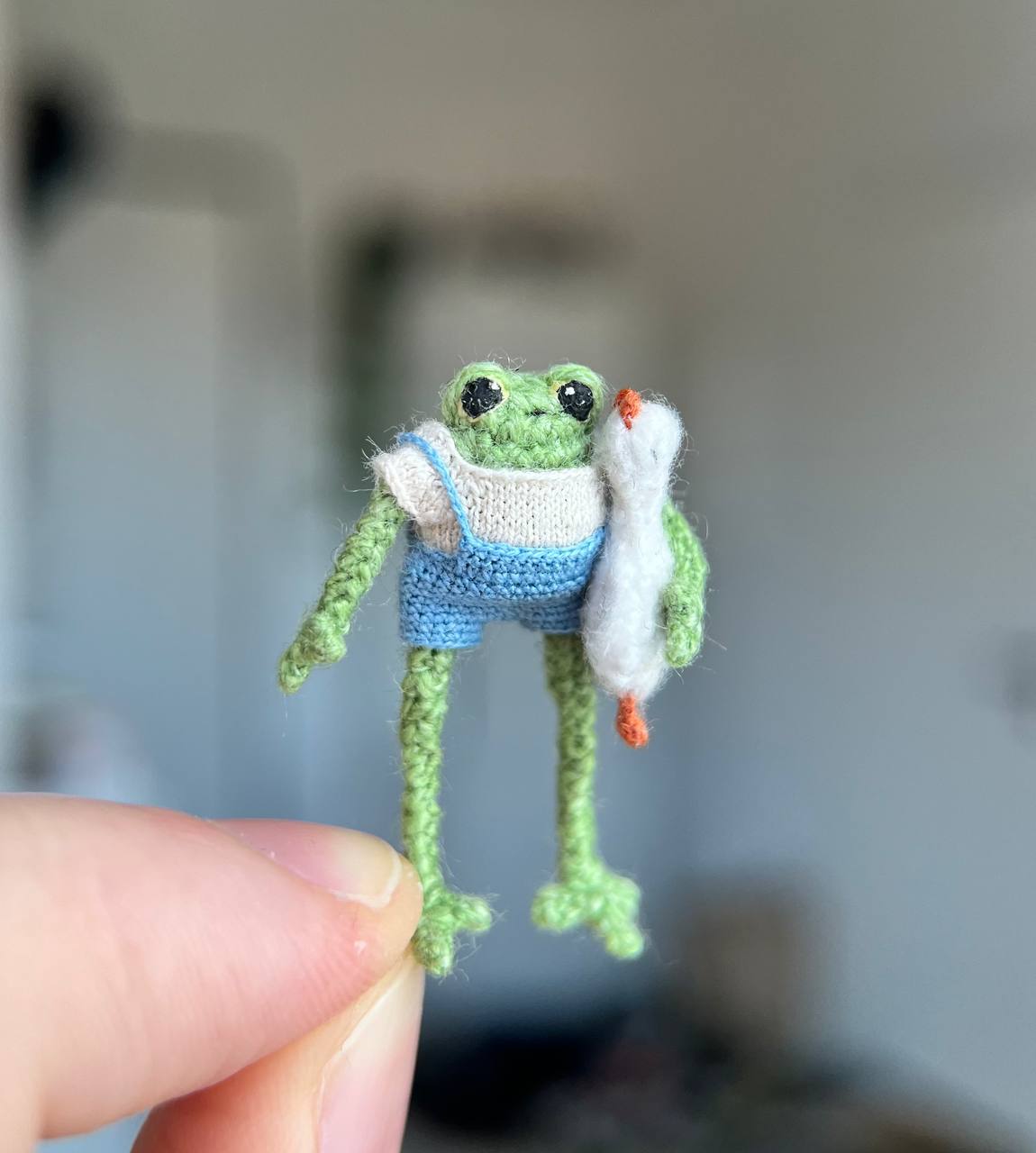 Super tiny crochet frog with a plush goose